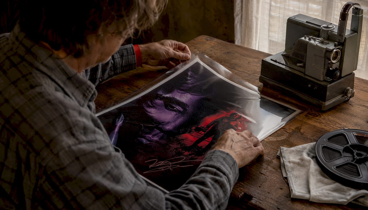 Hands handling signed limited edition film poster