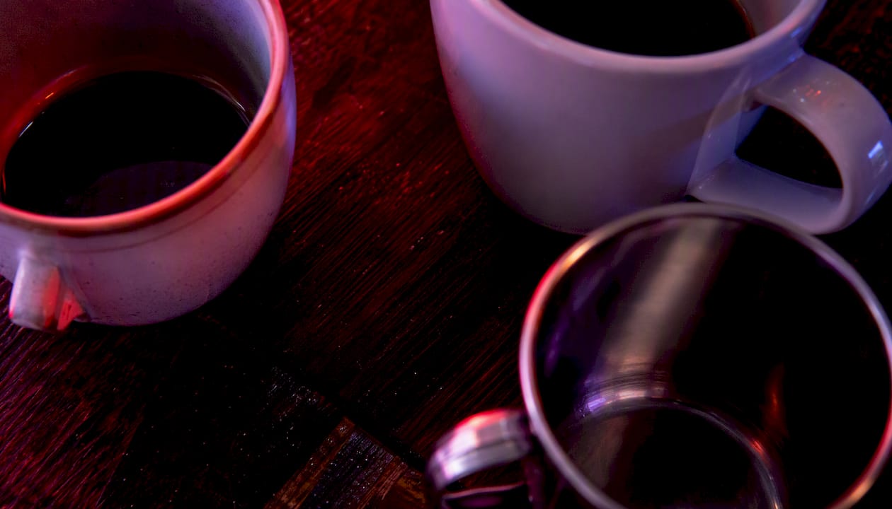 Three mugs showing ceramic, porcelain, and steel materials