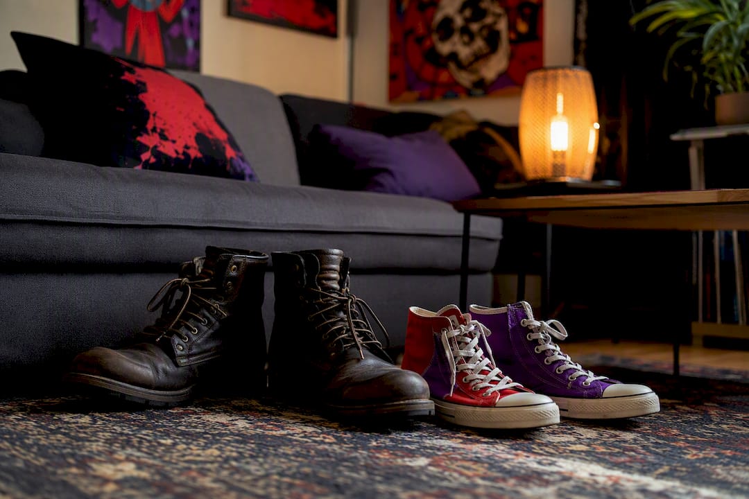 Leather boots and canvas sneakers side by side