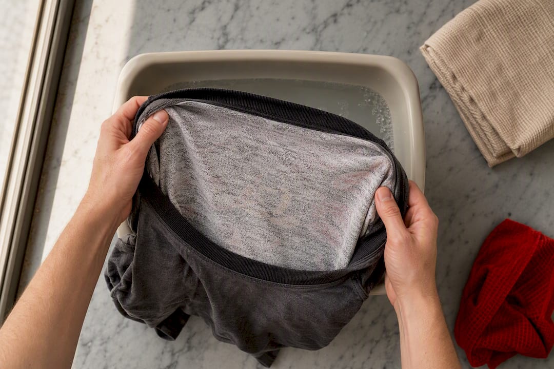 Hands turning a graphic tee inside out