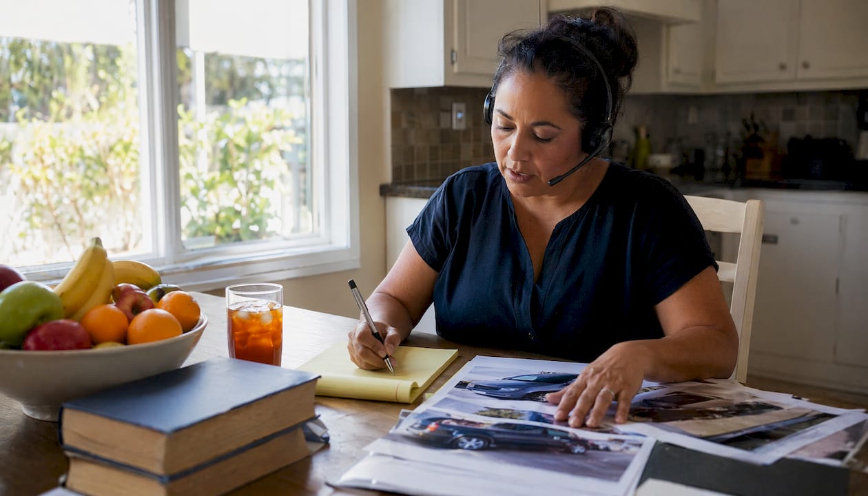 Woman preparing car accident claim at home desk