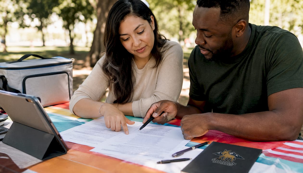 Hands reviewing legal cost savings on paperwork