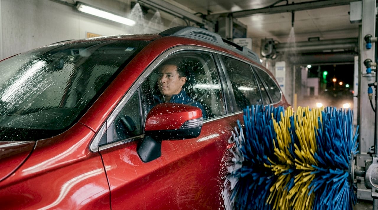 SUV in automatic car wash showing scratches