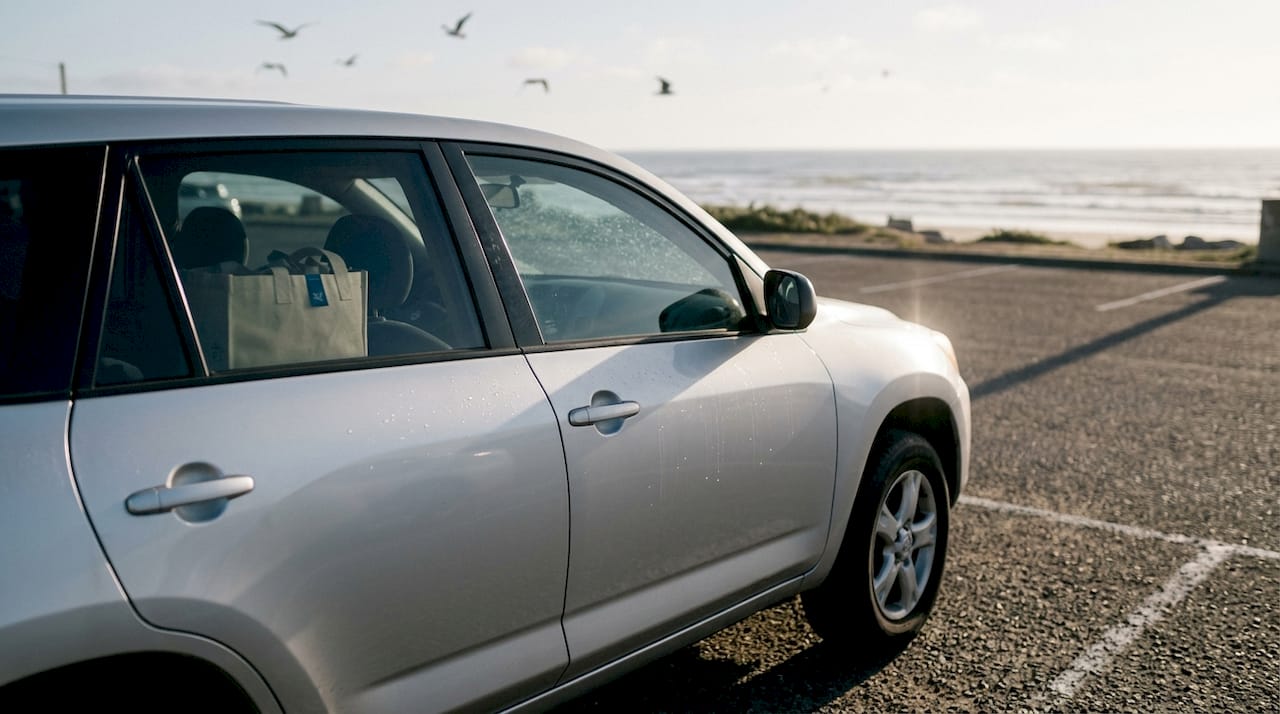Car parked near San Diego coast in sunlight