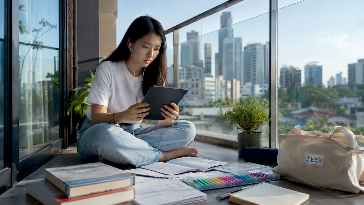 Young woman practicing bilingual education at home