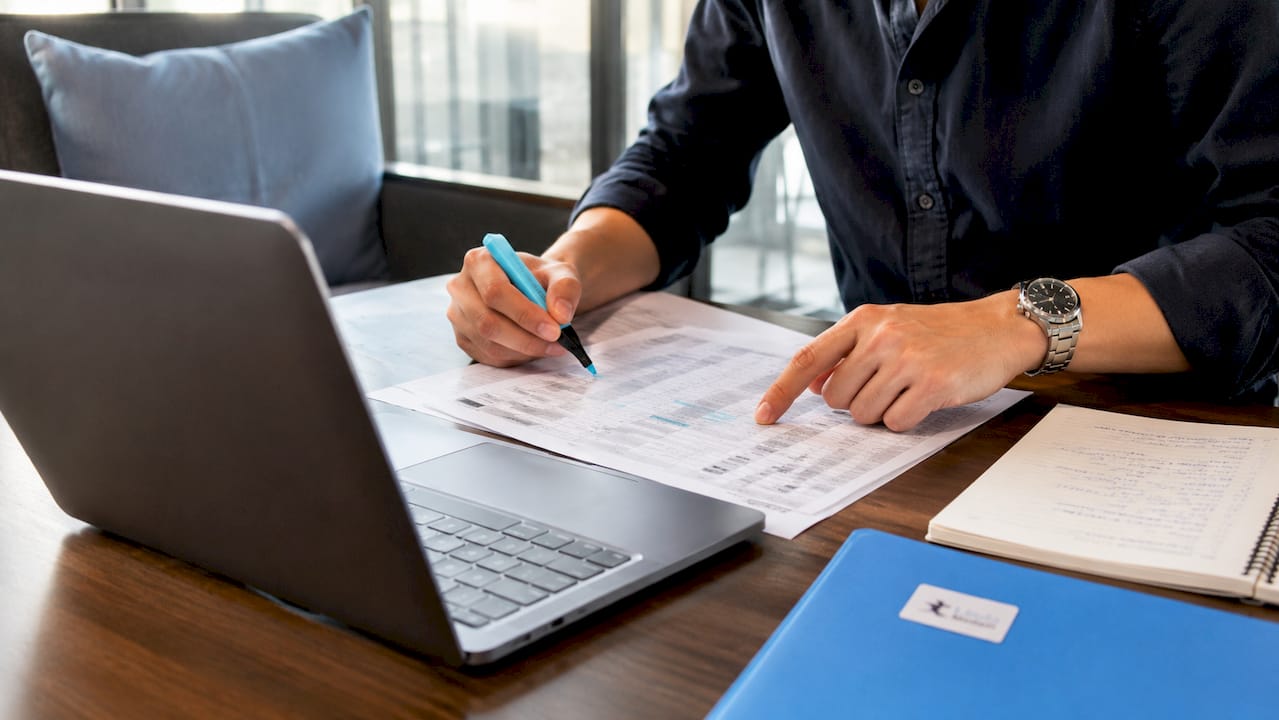 Hands reviewing Mandarin product specification documents