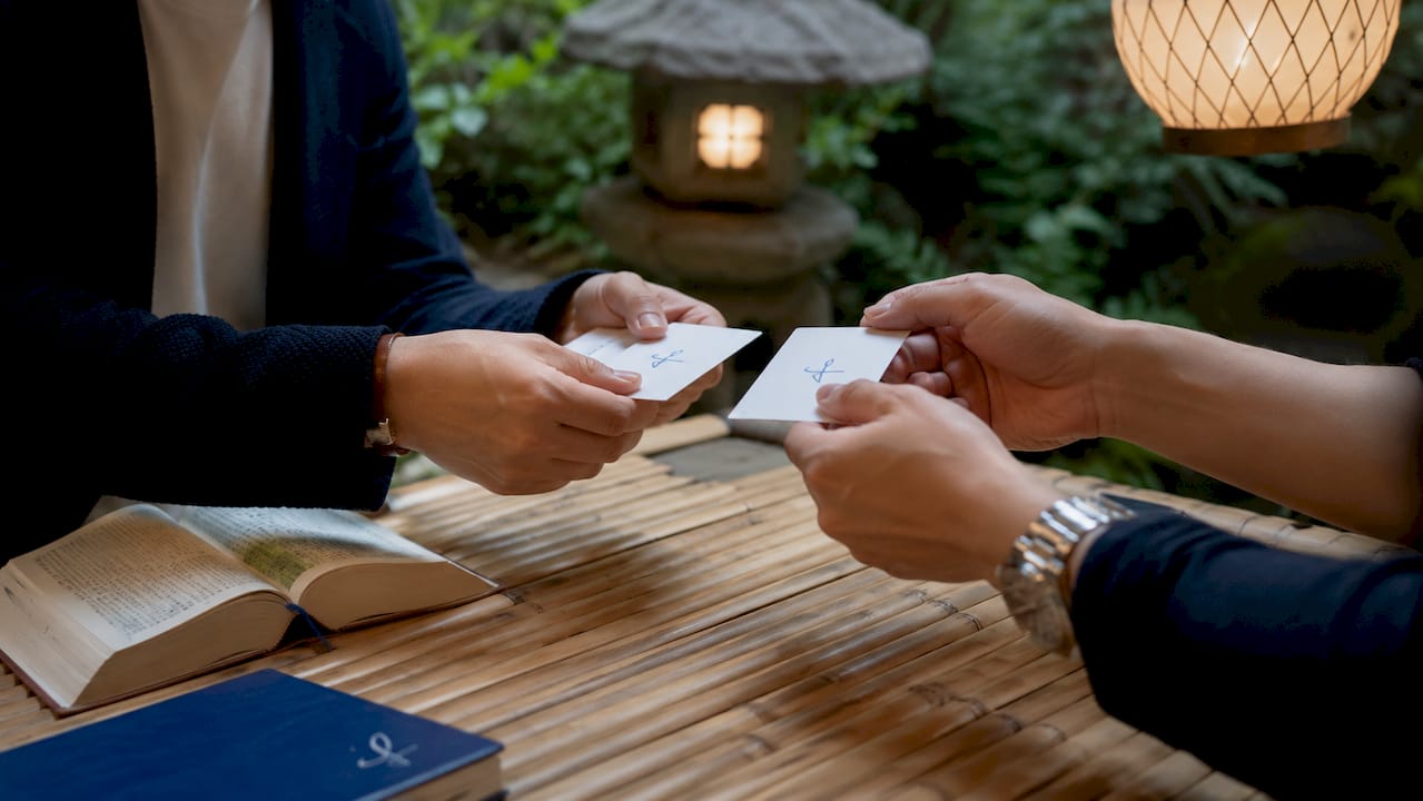 Close-up of business card exchange hands
