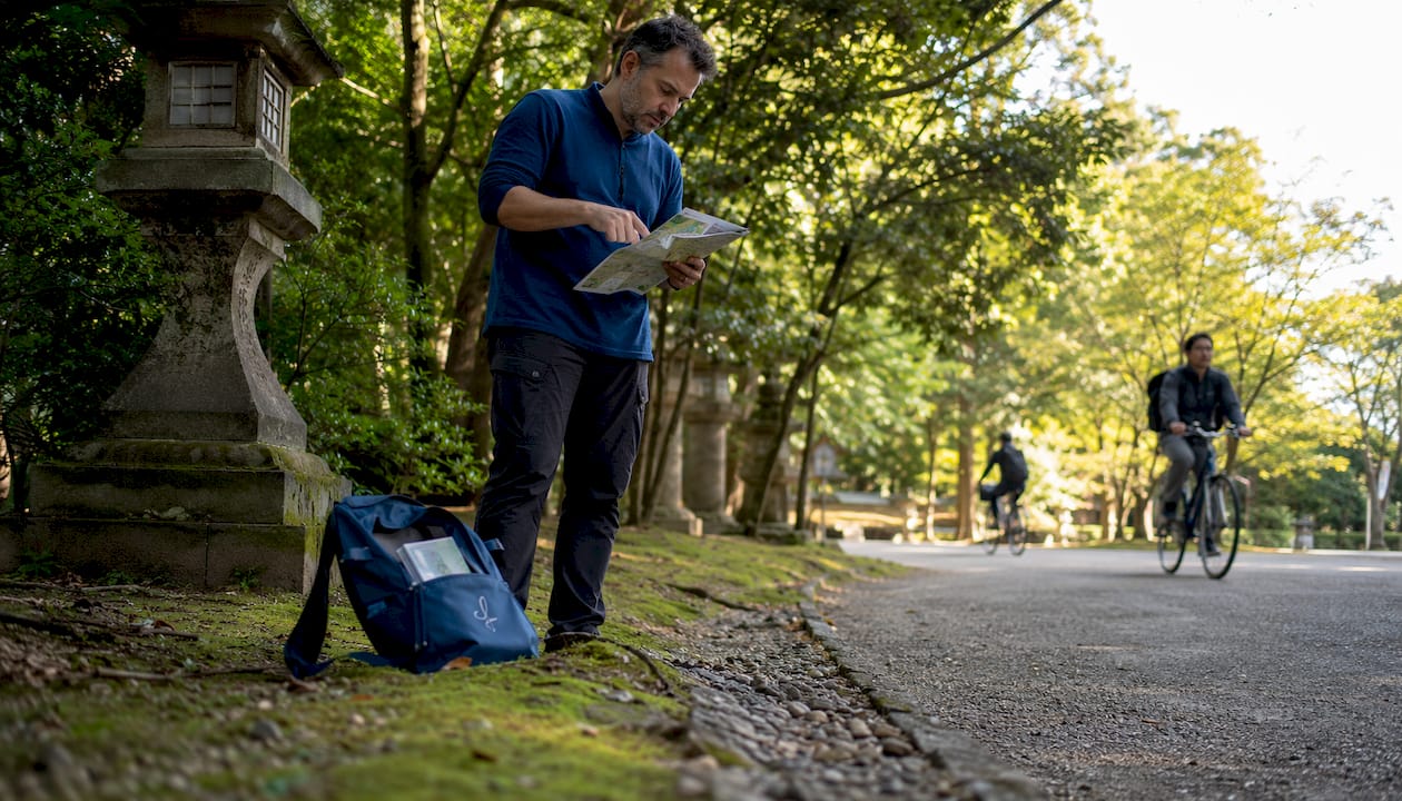 Traveler using map for directions on Japanese street