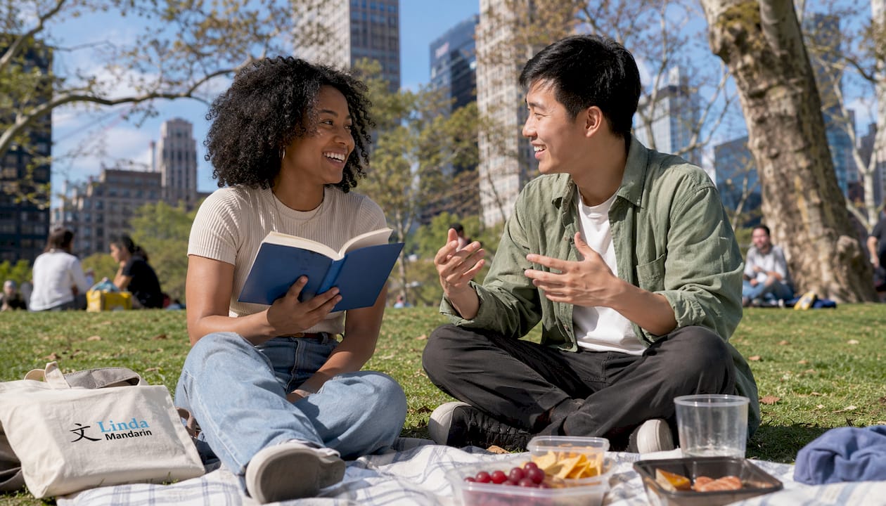 Friends practicing Mandarin while socializing outdoors