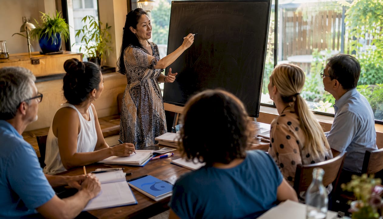 Adult learners studying Thai language in classroom