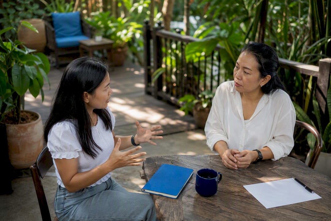 Learner role-playing Thai phone call with instructor