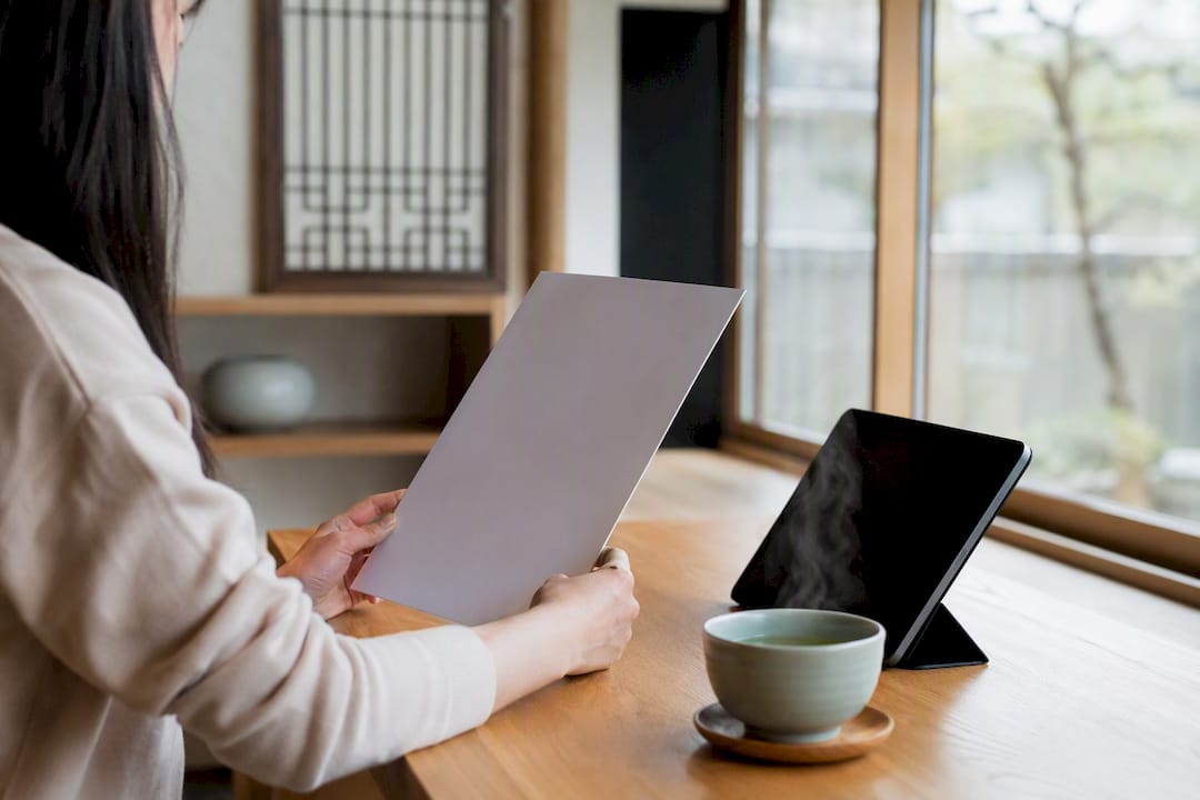 Hands holding blank document contract in office