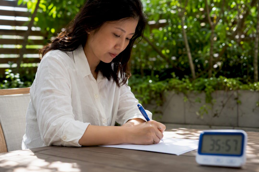 Hand writing Korean characters with timer nearby
