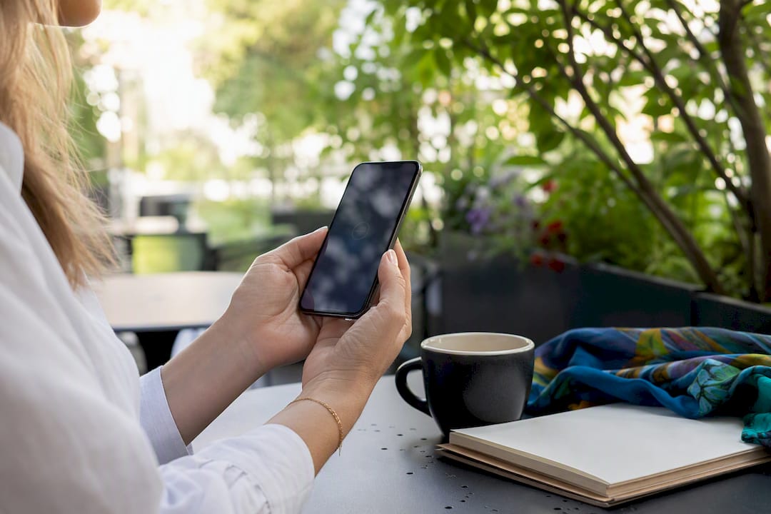 Hands holding smartphone after payment confirmation