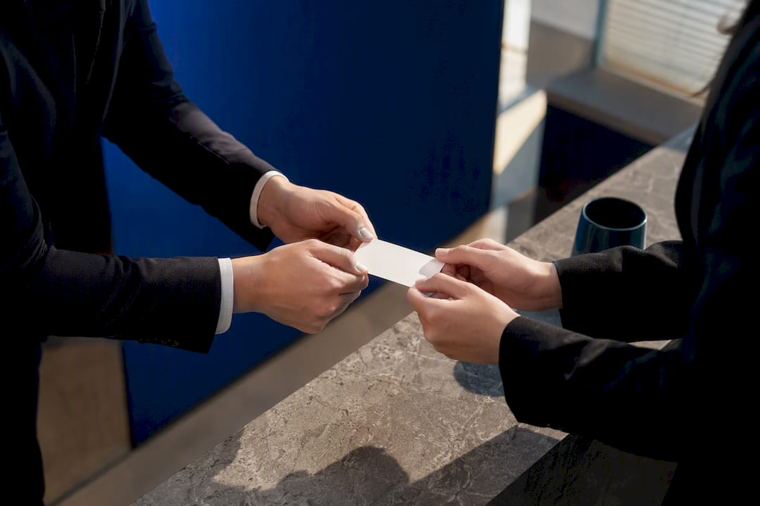 Professionals exchanging business card respectfully