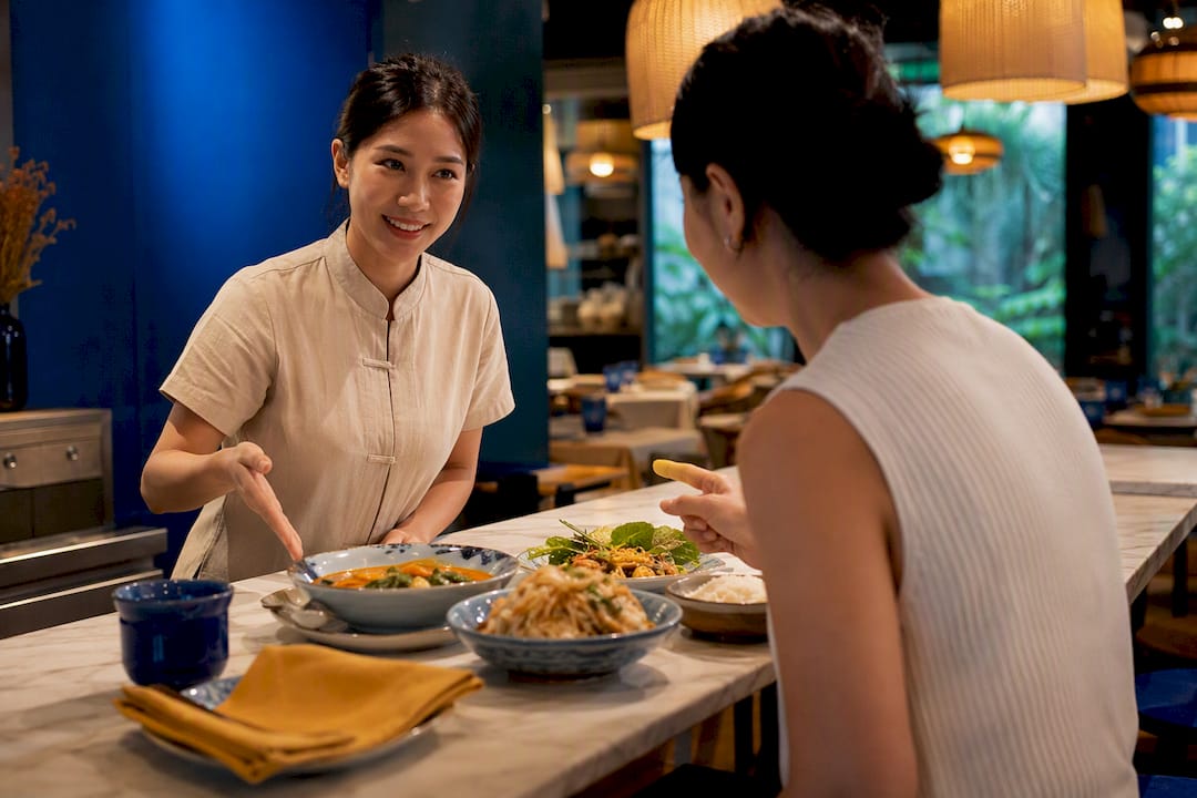 Learner ordering food in Thai restaurant