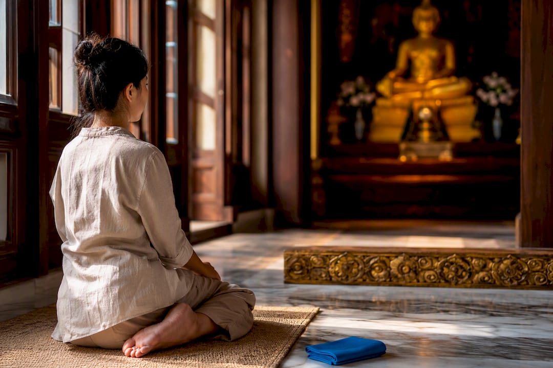 Respectful seated posture inside Thai temple