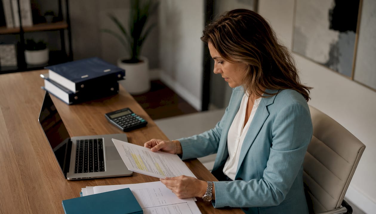 Accountant reviewing structured text documents at desk