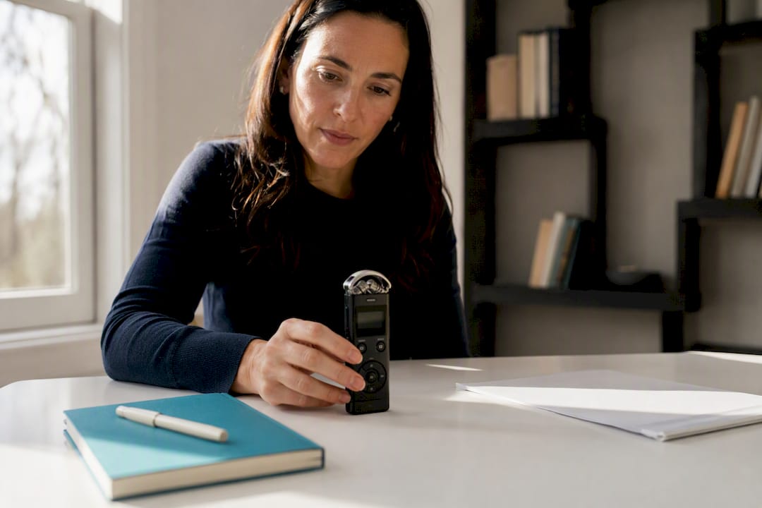 Coach adjusting recording device on table