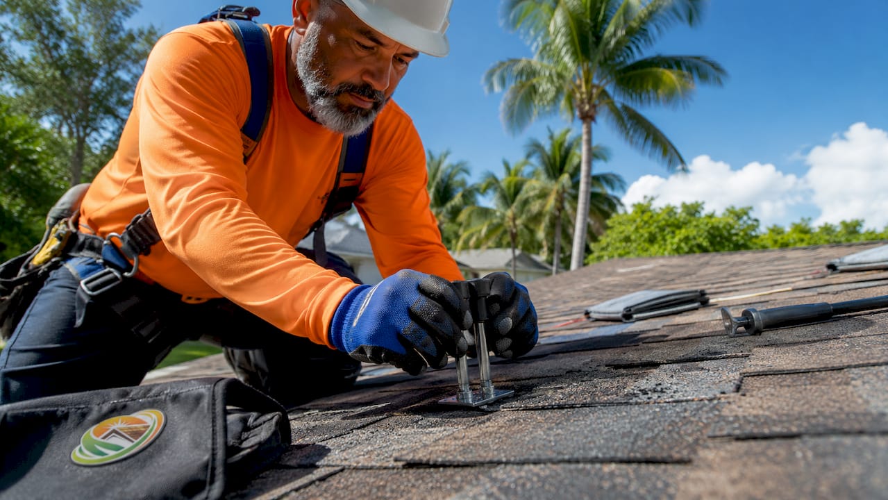 Contractor performing roof adhesion test on shingles
