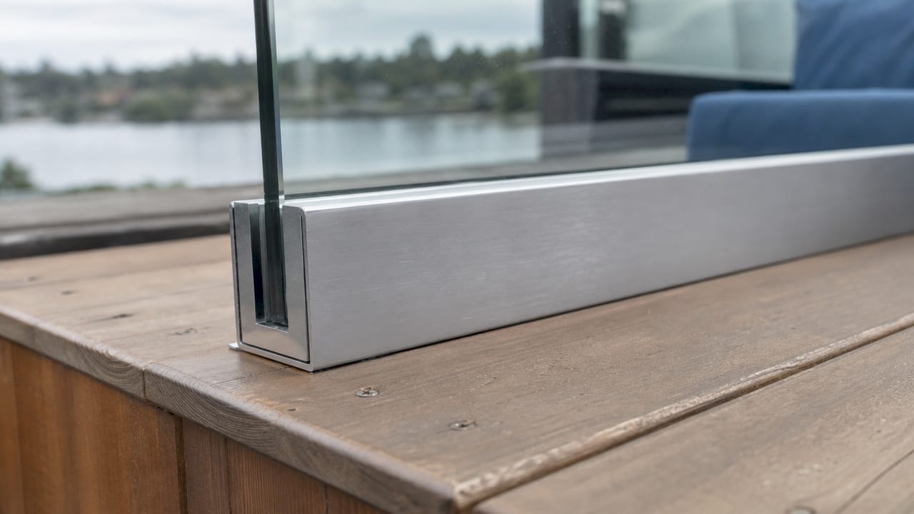 Close-up of glass railing surface mount hardware