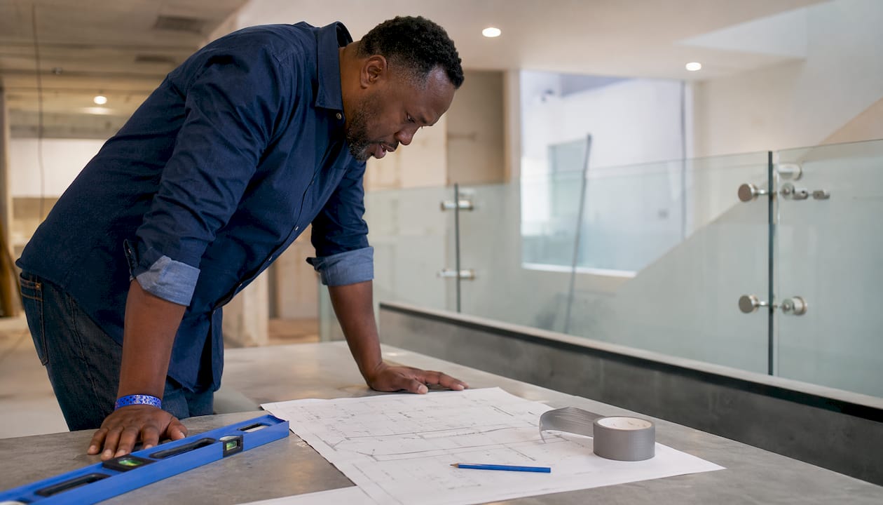 Contractor reviewing glass railing installation blueprints