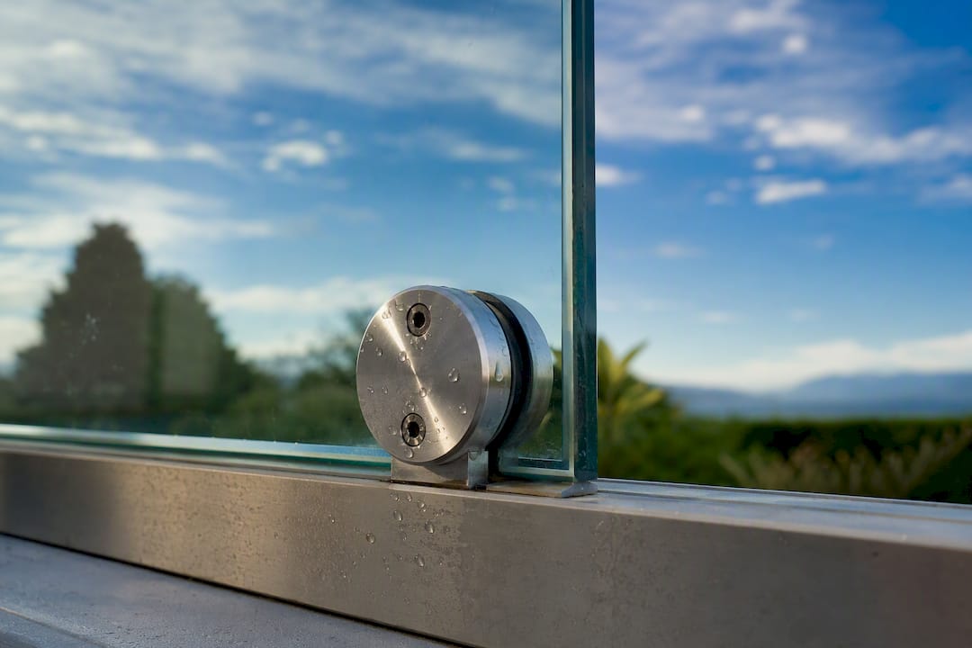 Patch fitting on frameless glass panel corner
