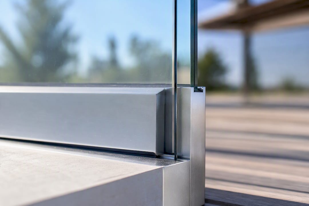 Metal channel holding glass edge in heat