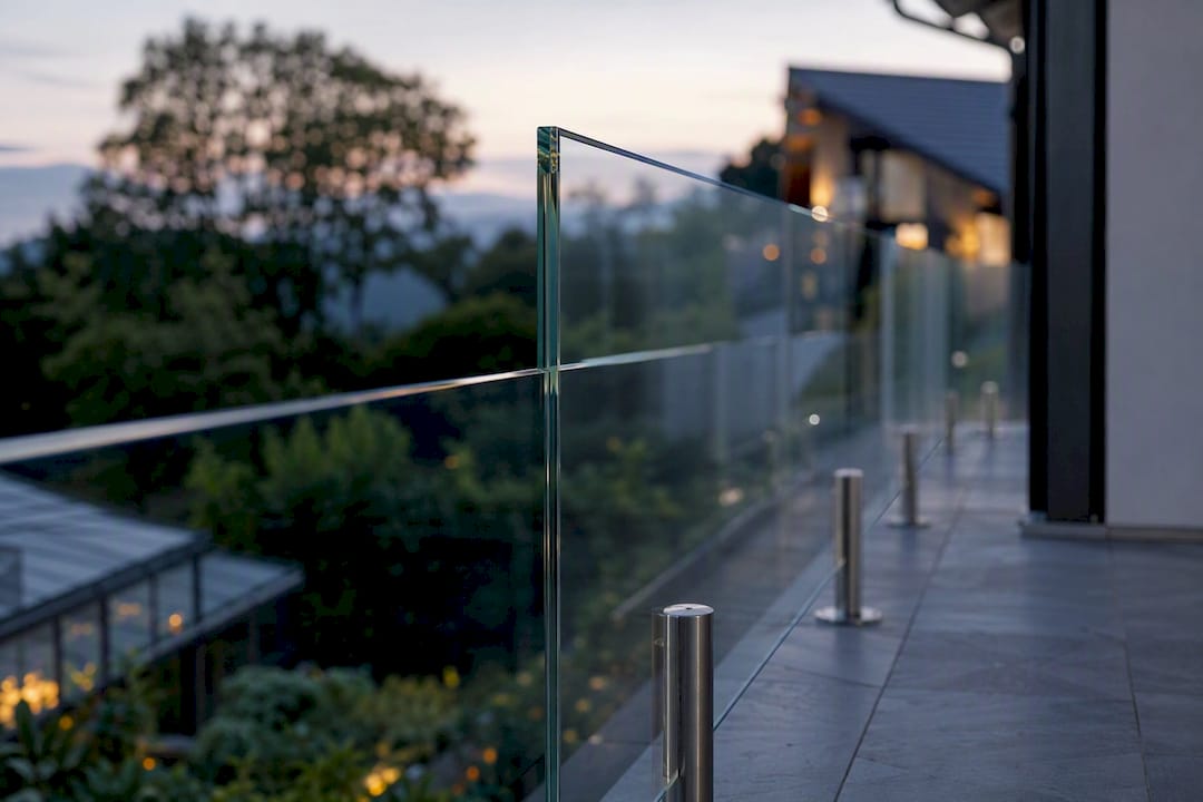 Balcony with frameless glass railing mockup at dusk