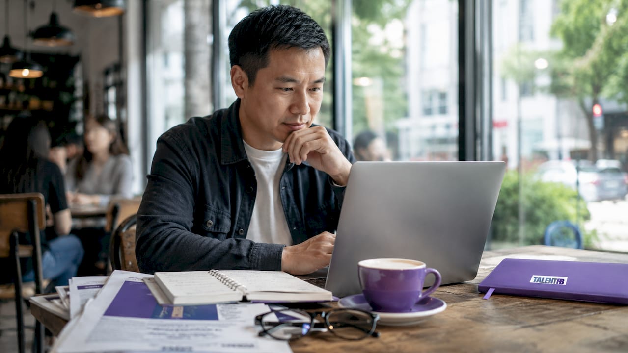 Professional preparing LinkedIn profile at home office