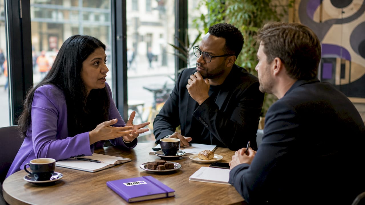 Executive team discussing culture fit in conference room