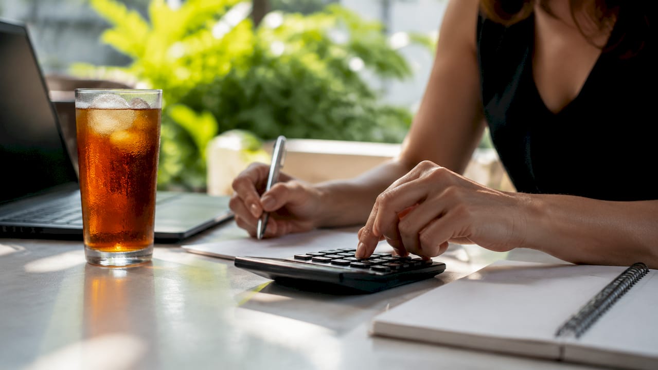 Hands calculating rental income versus mortgage