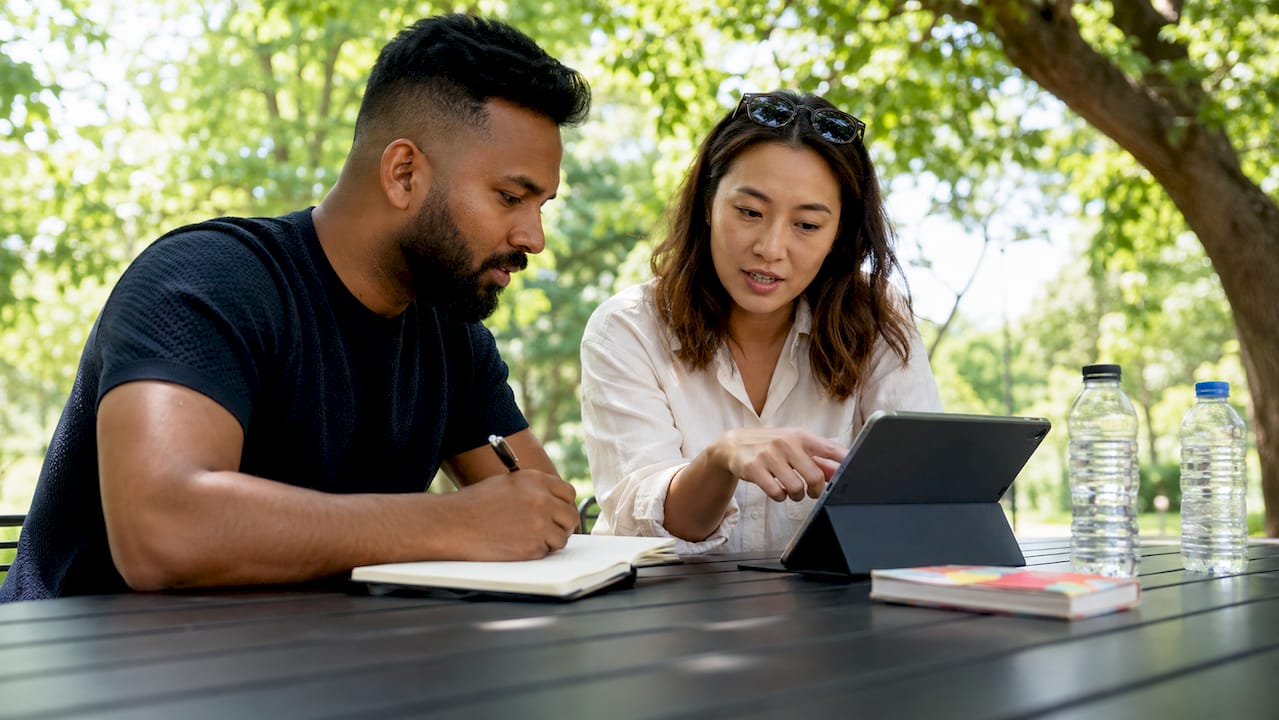Investors discussing rental yield figures in café