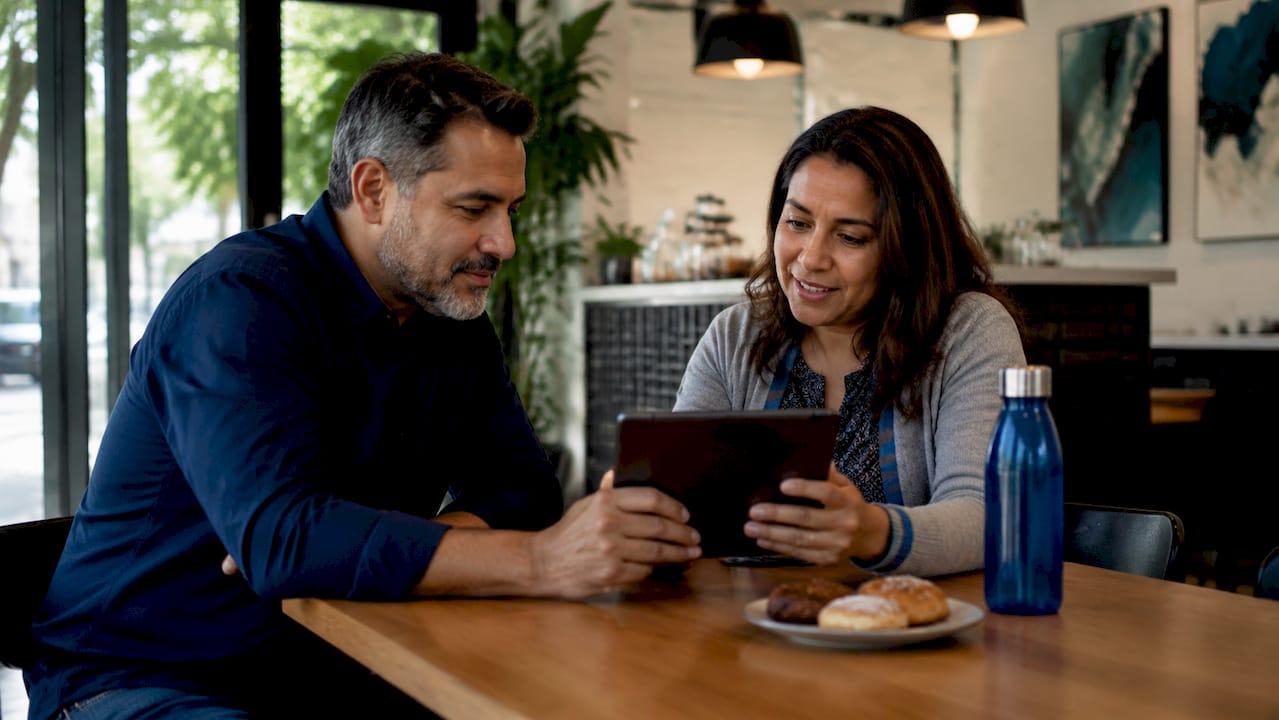 Couple discussing property investment options at home sofa