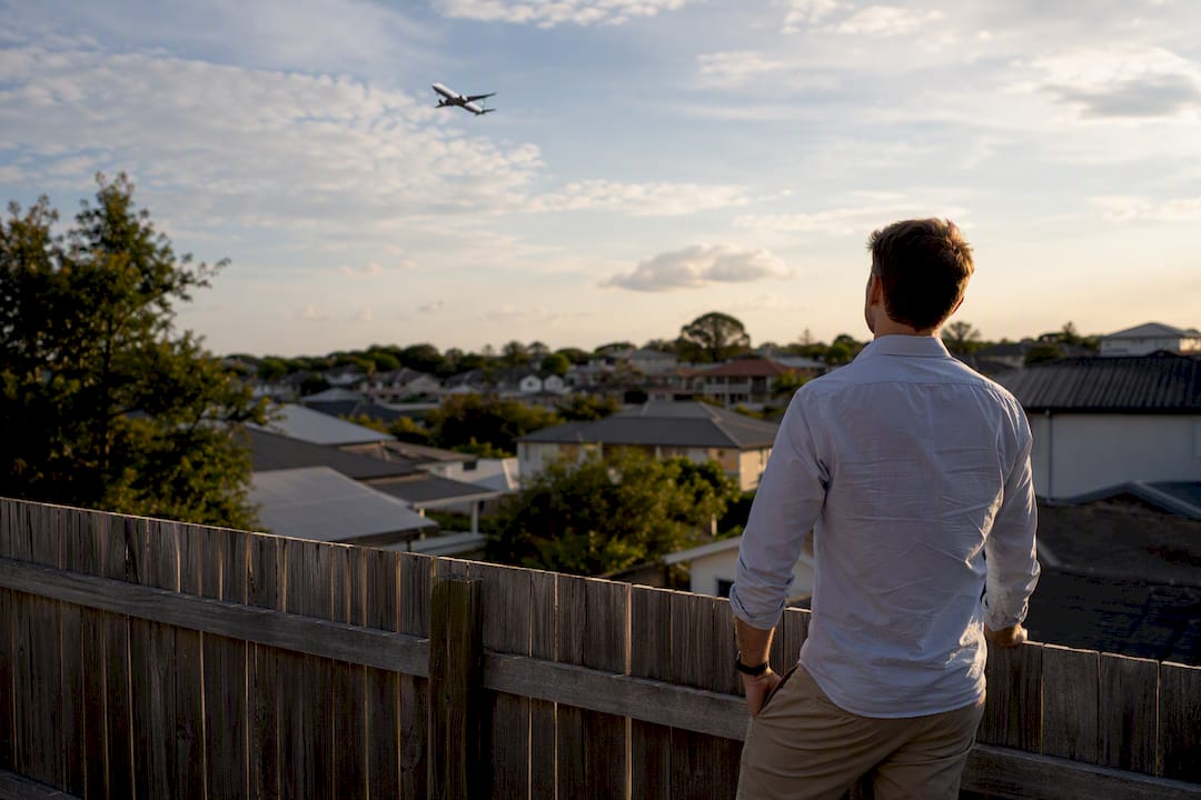 Buyer assessing suburban property near flight path