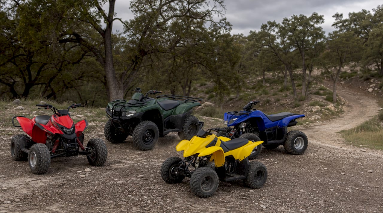 Four distinct ATV types outdoors on trail