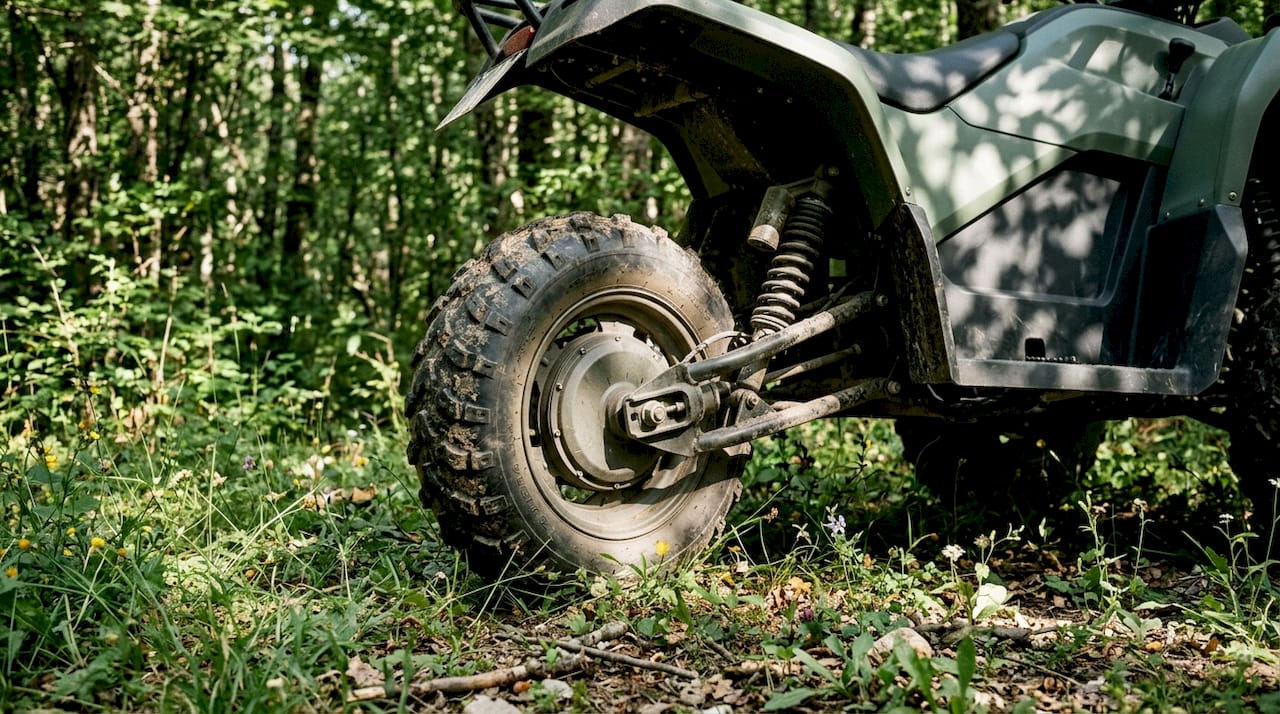 Close-up electric ATV near horse stable outdoors