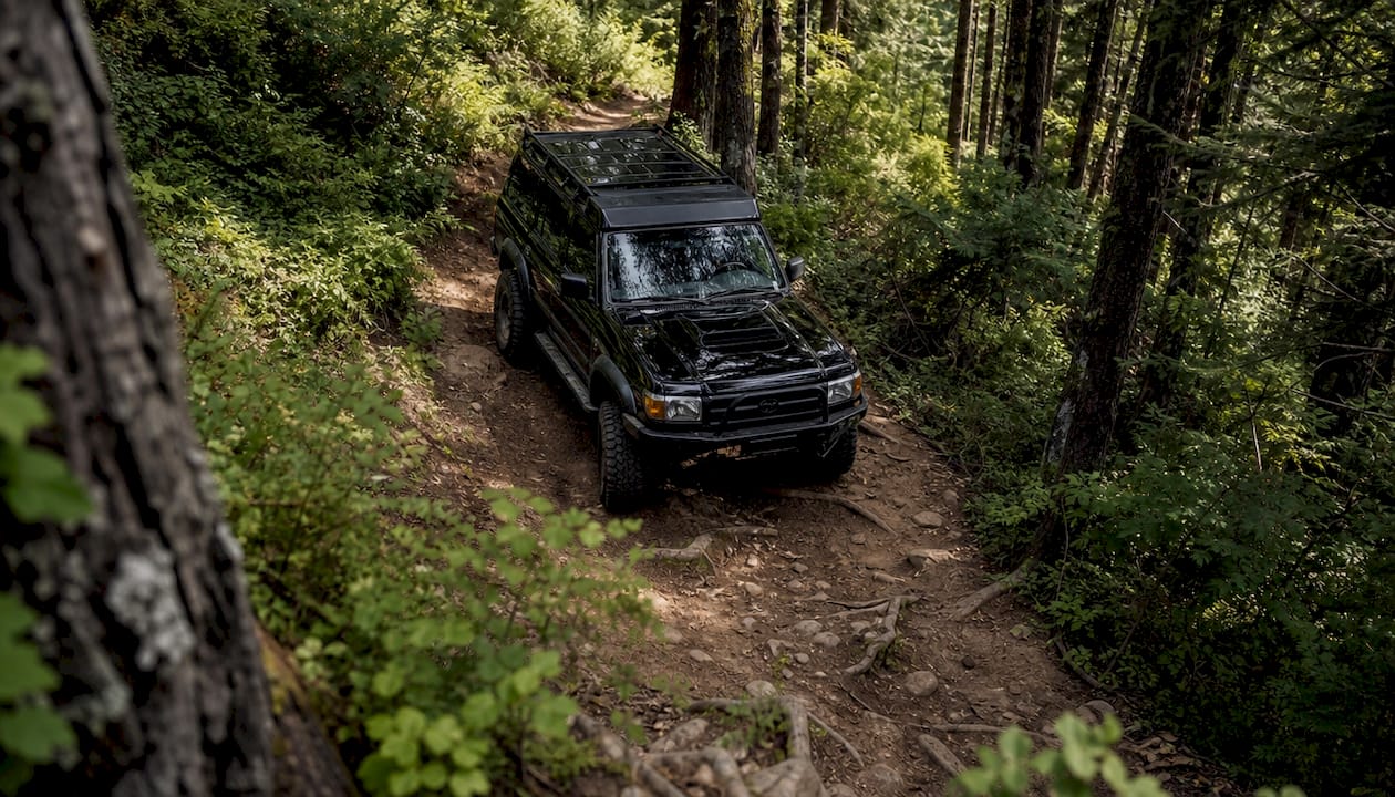 Off-road SUV climbing rocky mountain trail