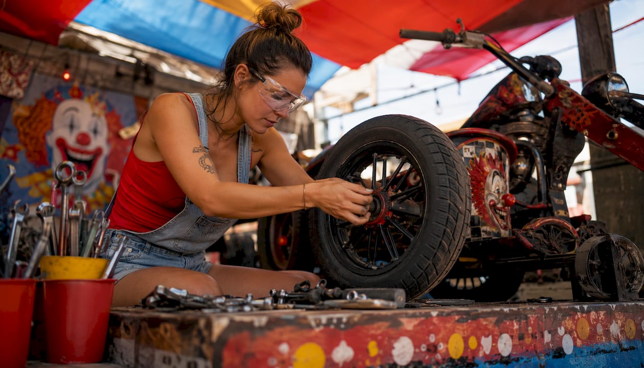 Woman working on motor trike conversion kit indoors
