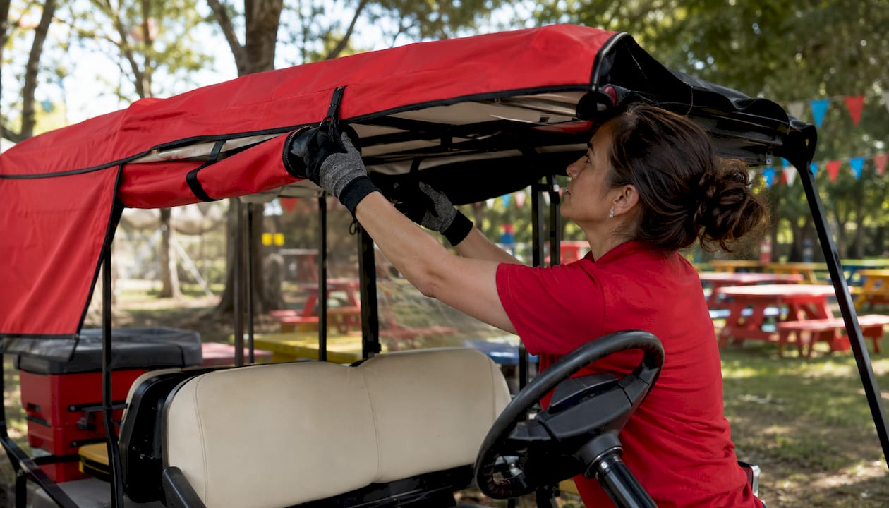 Technician installing canvas golf cart soft-top canopy