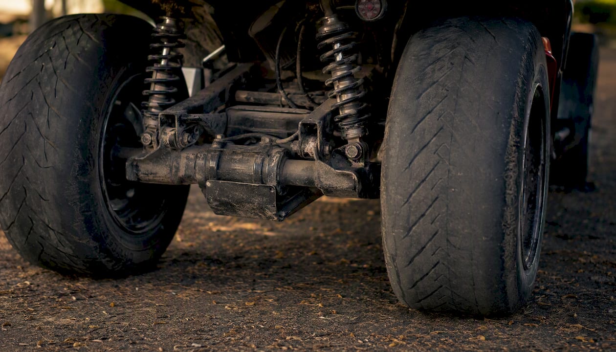 Close-up of rear tires showing uneven wear