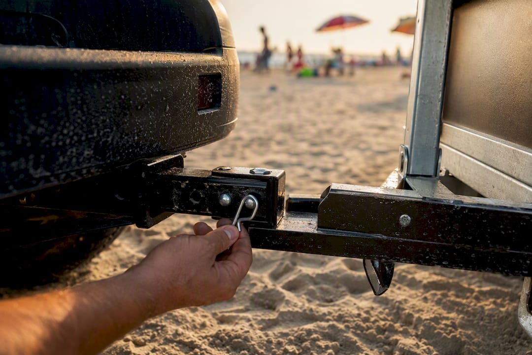 Hand attaching trailer hitch pin to receiver