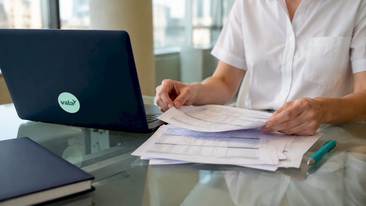 How Ai Detects Spending Patterns: A Clear Guide 2 Hands typing amid transaction documents at office