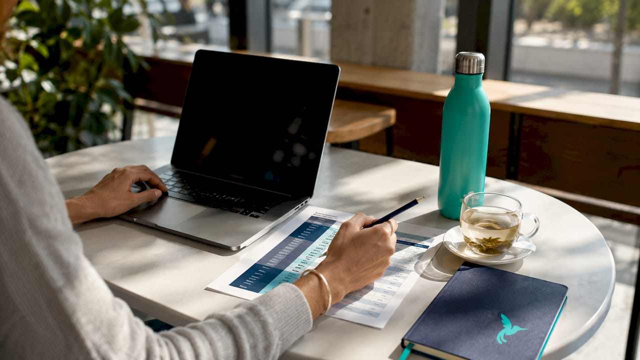 What Is A Spending Limit? A Personal Finance Guide 2 Hands pointing at credit vs spending limit chart on desk