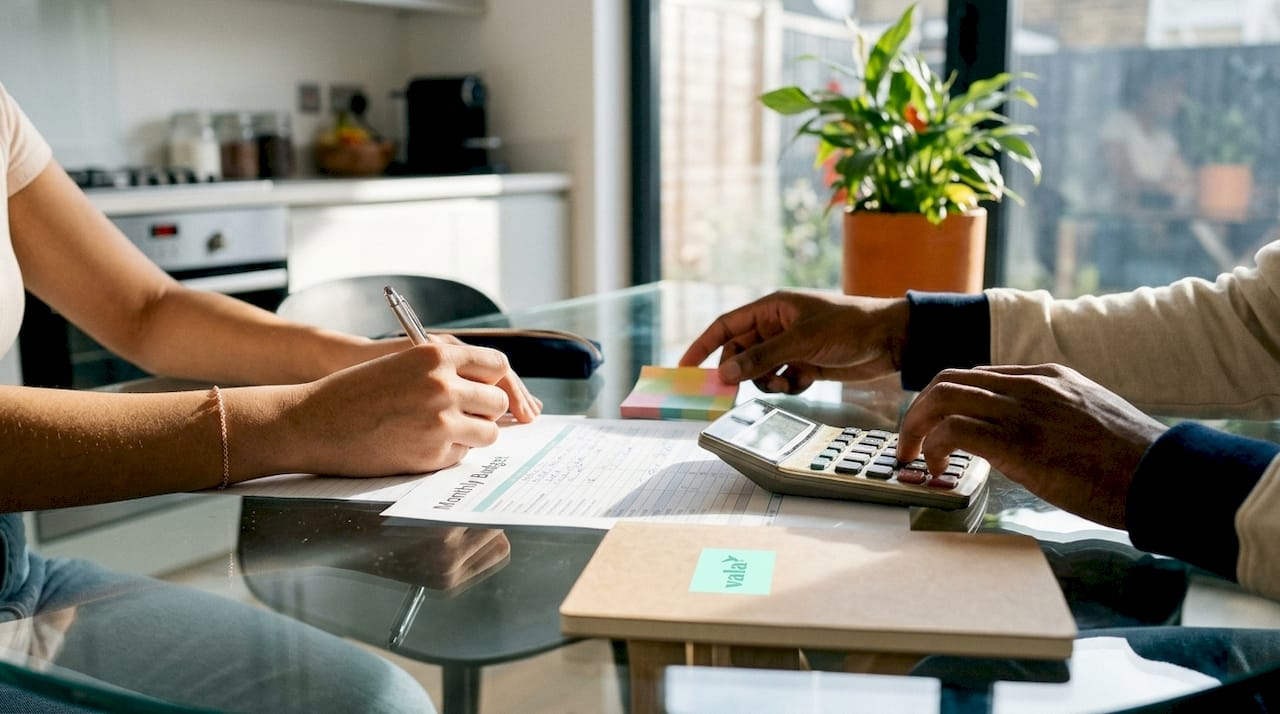 Close-up of hands calculating budget