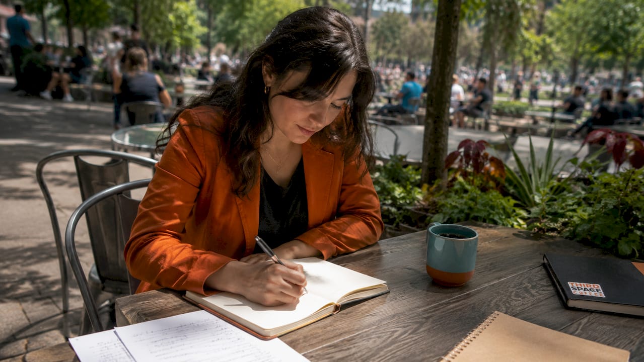 Professional preparing networking notes at cafe table