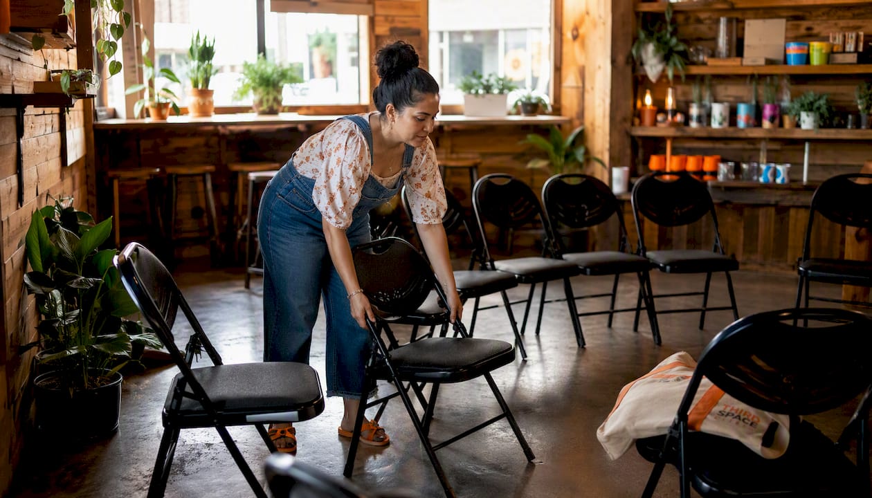 Organizer setting up chairs inside Thirdspacecoffee