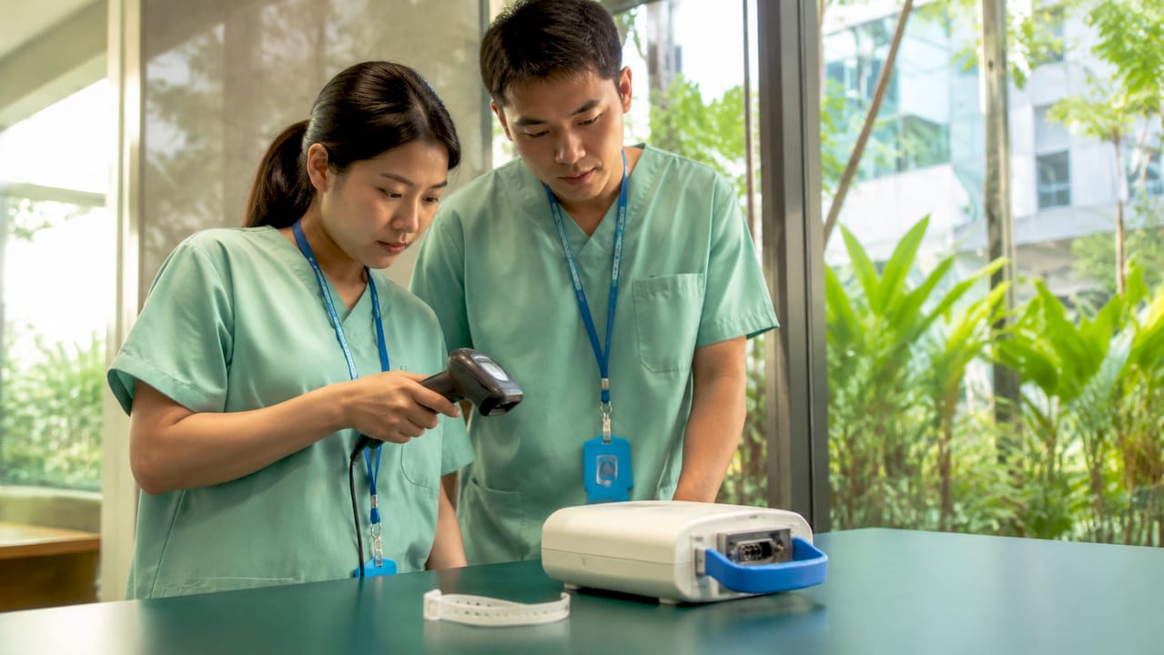Hospital staff scanning returned medical device