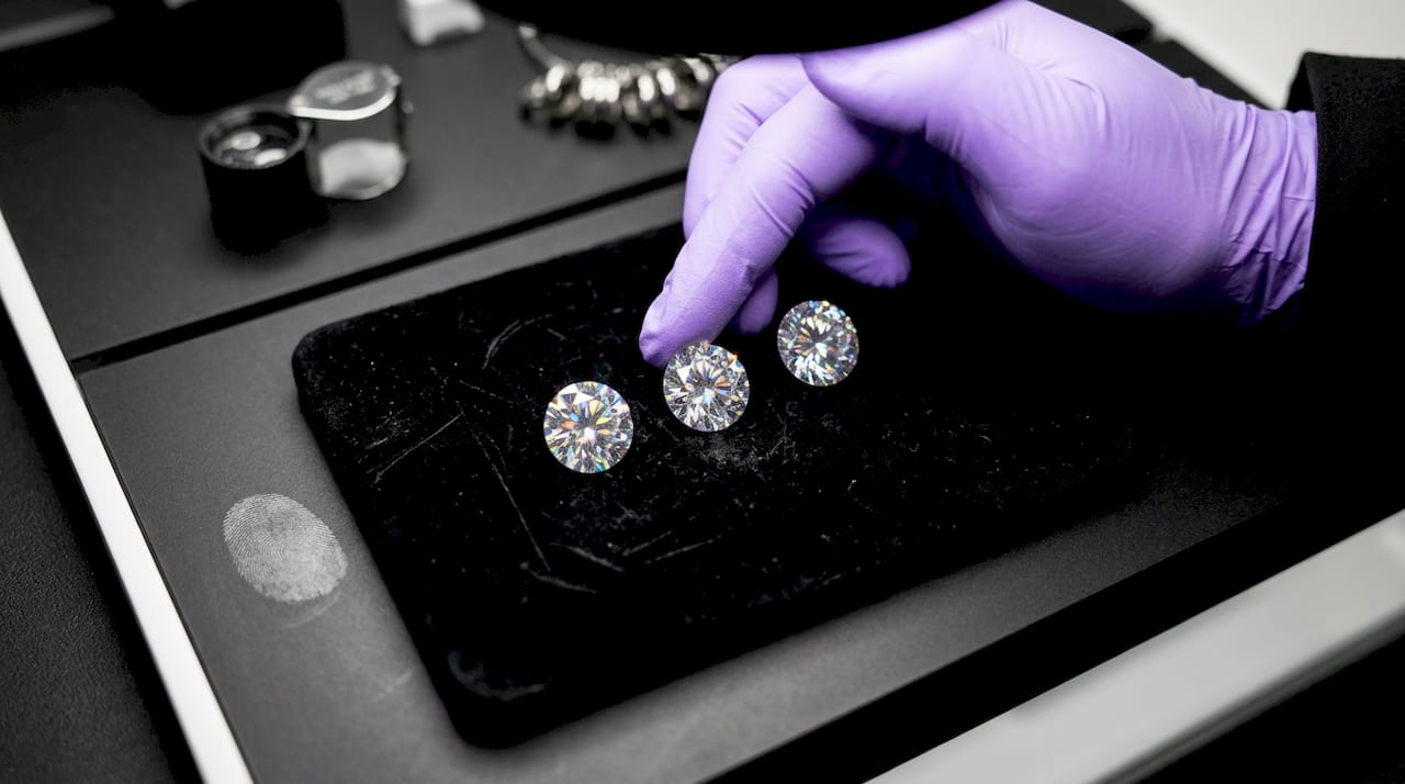 Three gemstones compared side by side on velvet