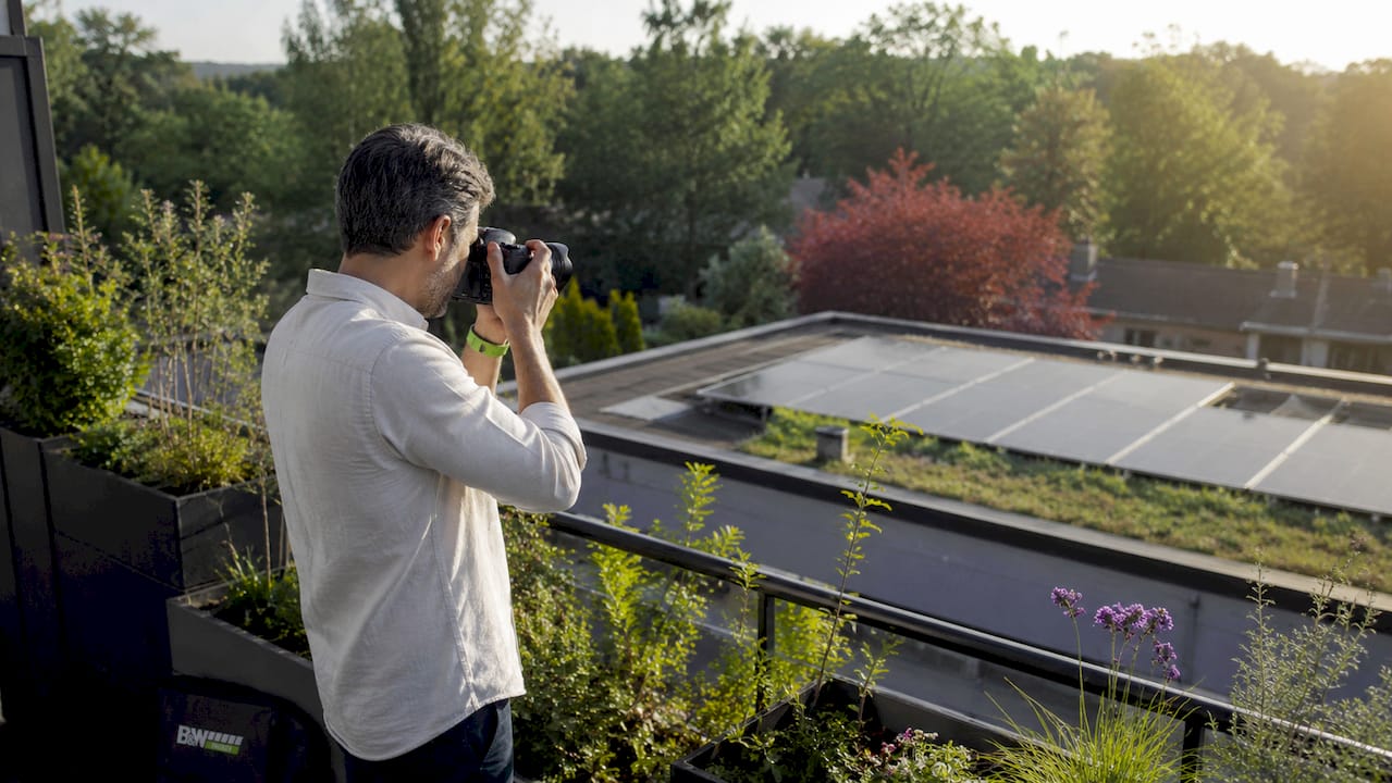 Ein Hausbesitzer macht Fotos von seiner Solaranlage, um den Zustand der Module zu überprüfen.